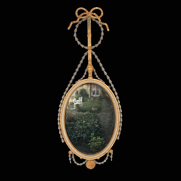 An oval partly gilt Louis XVI mirror. Denmark circa 1790. H: 116cm. W: 47cm